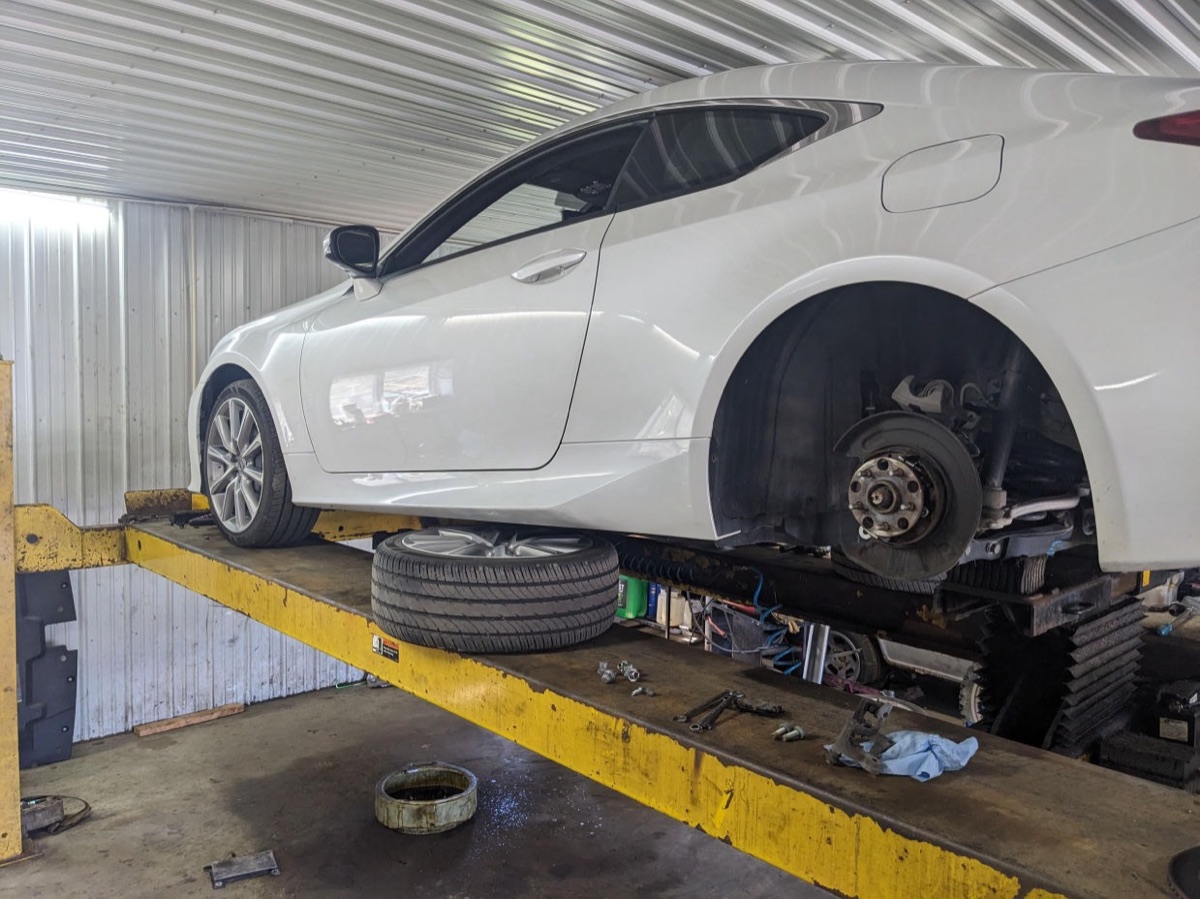 Car up on the lift for repair at Huth Auto Services